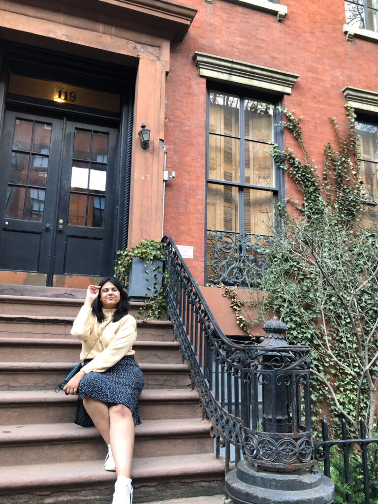 Girl posing on the steps in east village for instagram Manhattan New York 