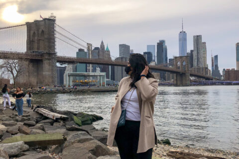 Picture of a girl tourist at the waterfront at Brooklyn Bridge Park at sunset
