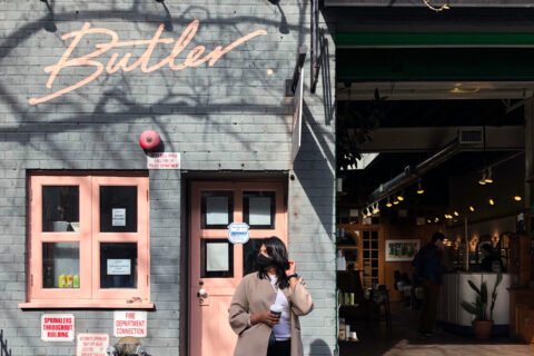 Picture of a girl outside the facade of butler in Brooklyn NY