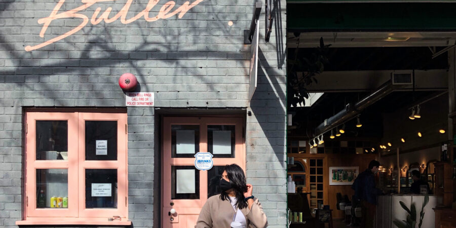 Picture of a girl outside the facade of butler in Brooklyn NY
